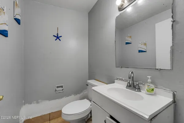 a bathroom with a sink a toilet and mirror