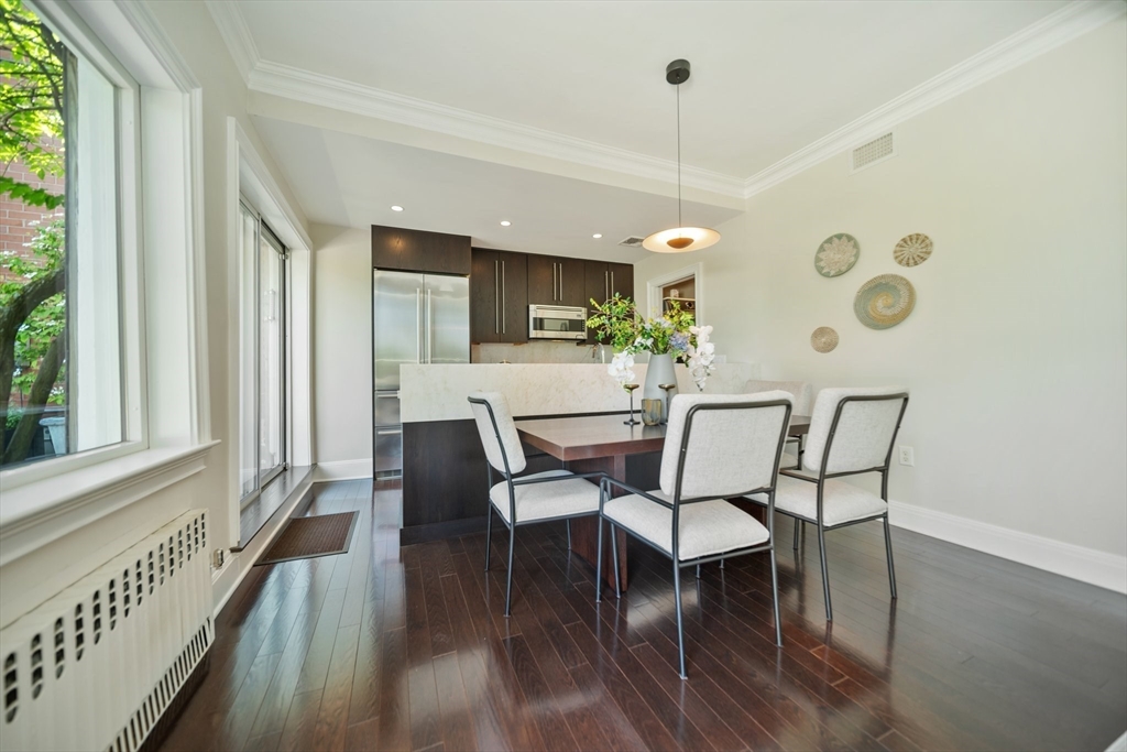 56 Commonwealth Avenue, Unit PH Boston, MA 02116 - Photo 12 of 33 a dining room with furniture a chandelier and wooden floor