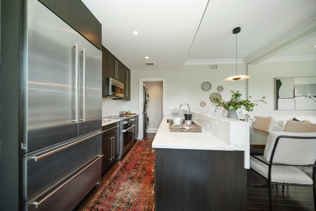 56 Commonwealth Avenue, Unit PH Boston, MA 02116 - Photo 13 of 33 a kitchen with kitchen island a counter top space appliances and cabinets