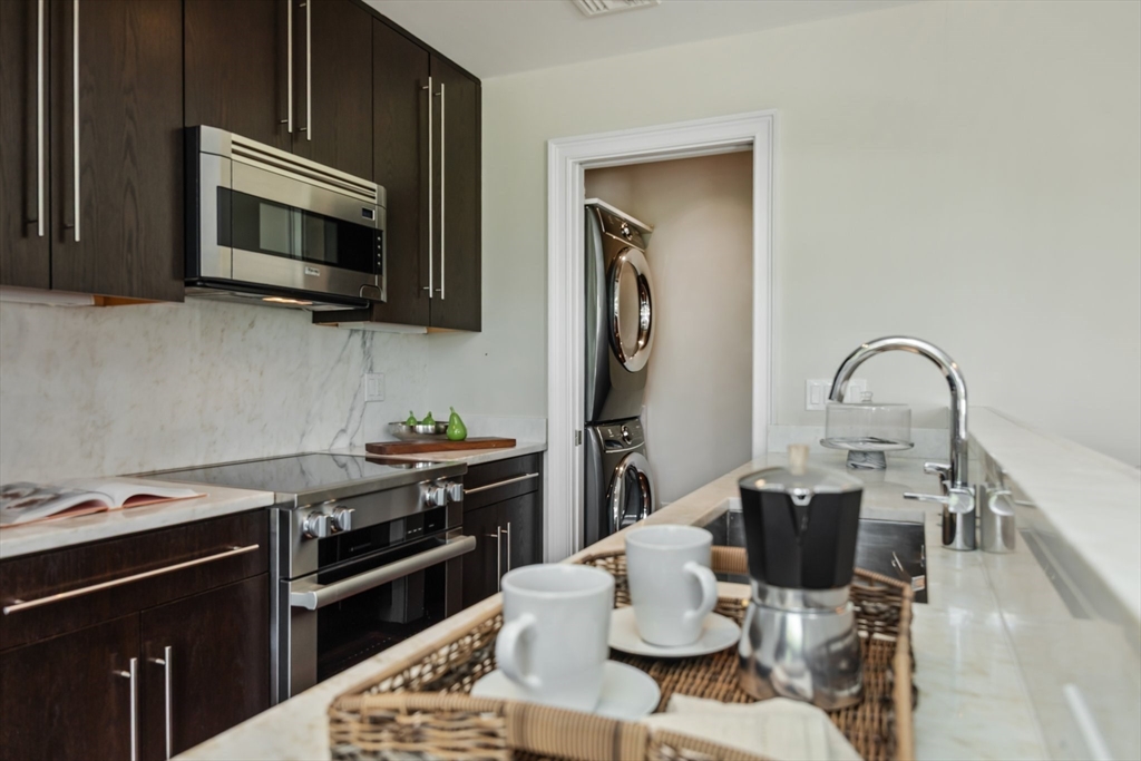 56 Commonwealth Avenue, Unit PH Boston, MA 02116 - Photo 14 of 33 a kitchen with a stove and a microwave