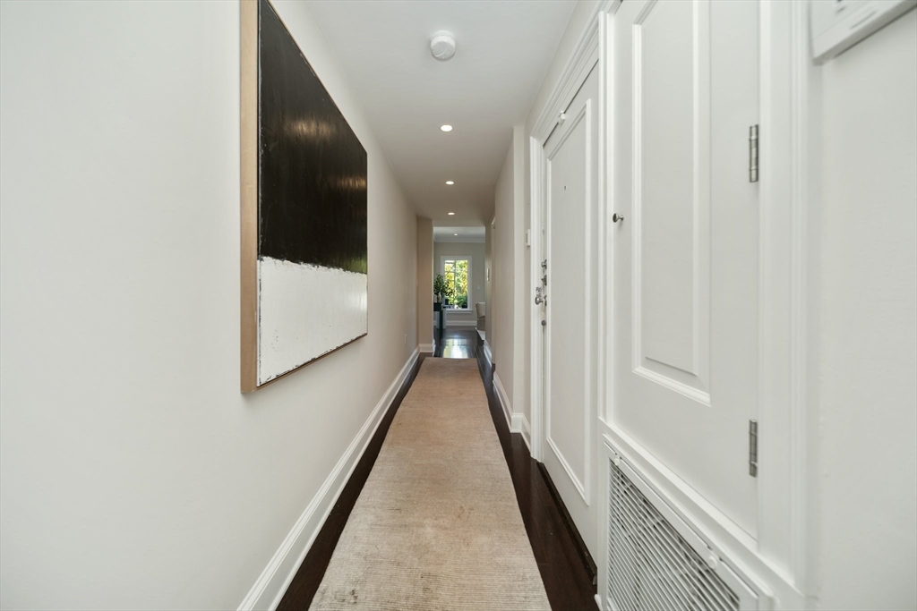 56 Commonwealth Avenue, Unit PH Boston, MA 02116 - Photo 16 of 33 a view of a hallway with wooden floor and staircase