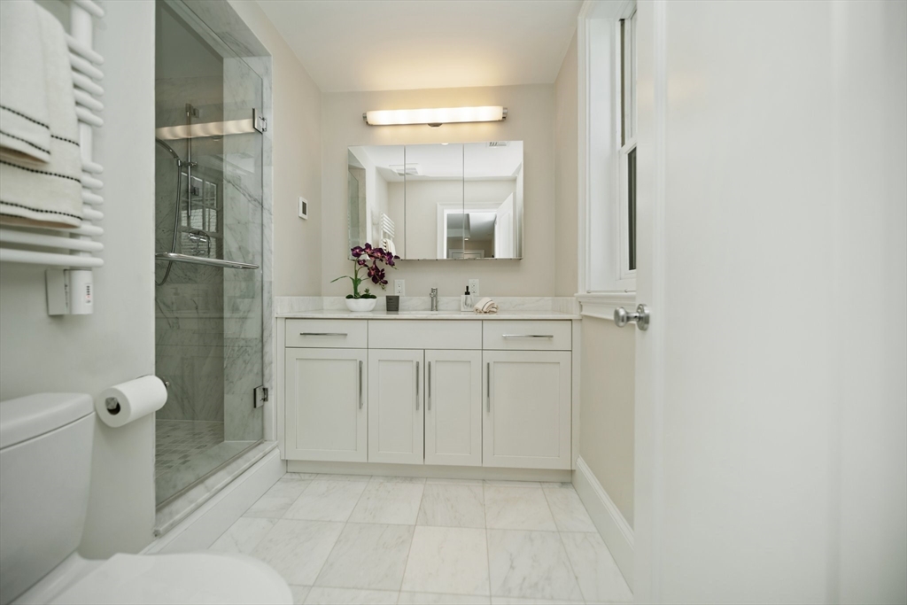 56 Commonwealth Avenue, Unit PH Boston, MA 02116 - Photo 18 of 33 a bathroom with a sink a toilet and shower