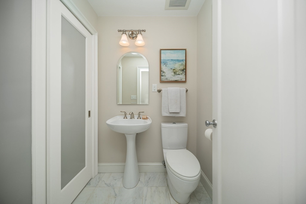 56 Commonwealth Avenue, Unit PH Boston, MA 02116 - Photo 23 of 33 a bathroom with a toilet sink and mirror