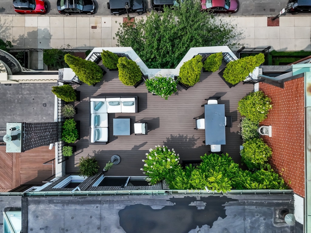 56 Commonwealth Avenue, Unit PH Boston, MA 02116 - Photo 29 of 33 an aerial view of a house with a garden and parking space