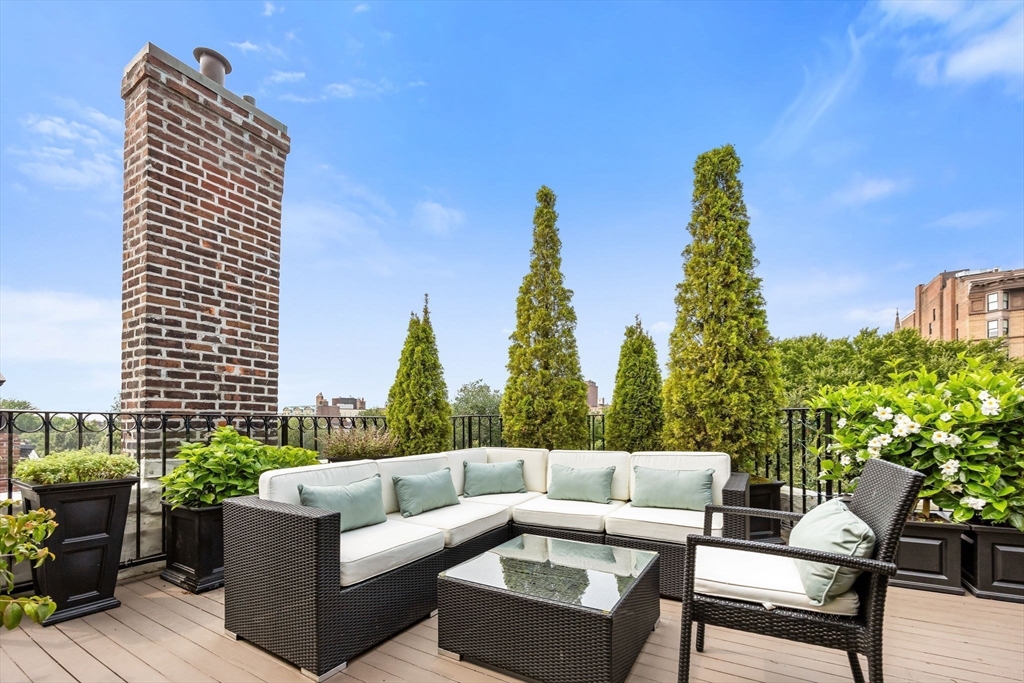 56 Commonwealth Avenue, Unit PH Boston, MA 02116 - Photo 8 of 33 a view of a terrace with couches and wooden fence