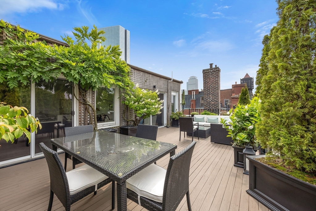 56 Commonwealth Avenue, Unit PH Boston, MA 02116 - Photo 10 of 33 a patio with table and chairs and potted plants