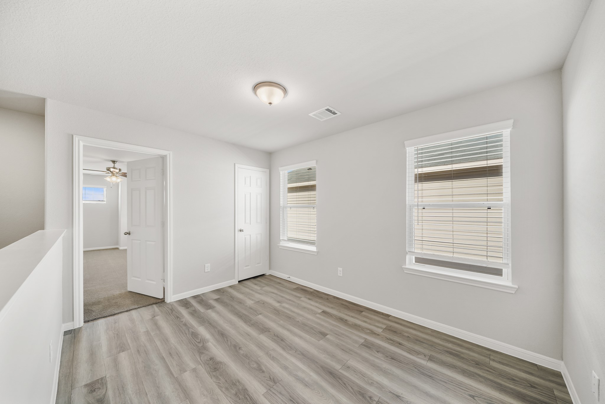 13309 Talisker Road Houston, TX 77048 - Photo 8 of 12 a view of empty room with wooden floor and fan