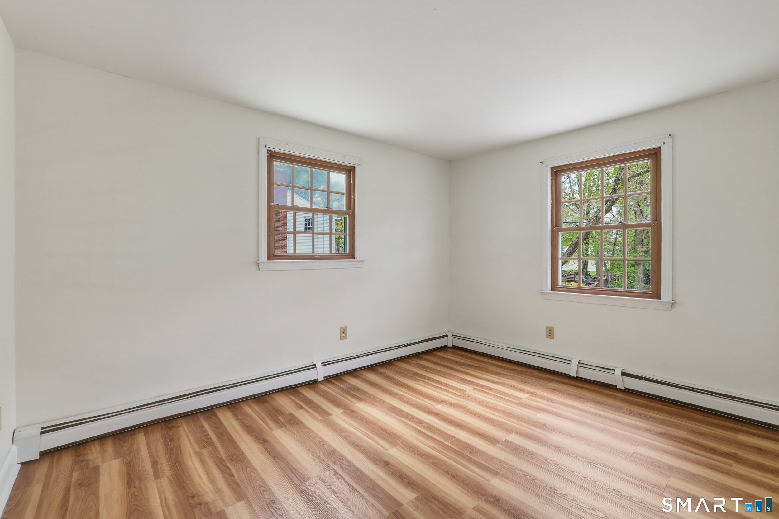 10 Salem Road Madison, CT 06443 - Photo 16 of 31 Newly installed vinyl floors combined with large windows make this bedroom feel large and inviting.