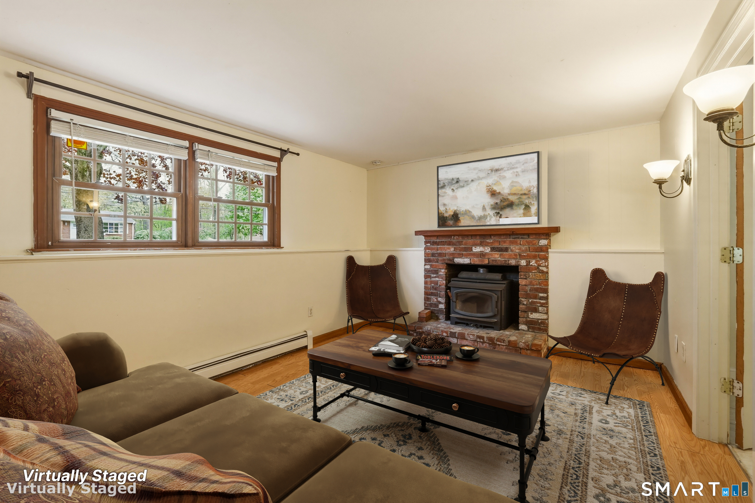 10 Salem Road Madison, CT 06443 - Photo 22 of 31 Located on the lower level, this family room is centered by a cozy fireplace with a wood stove insert.