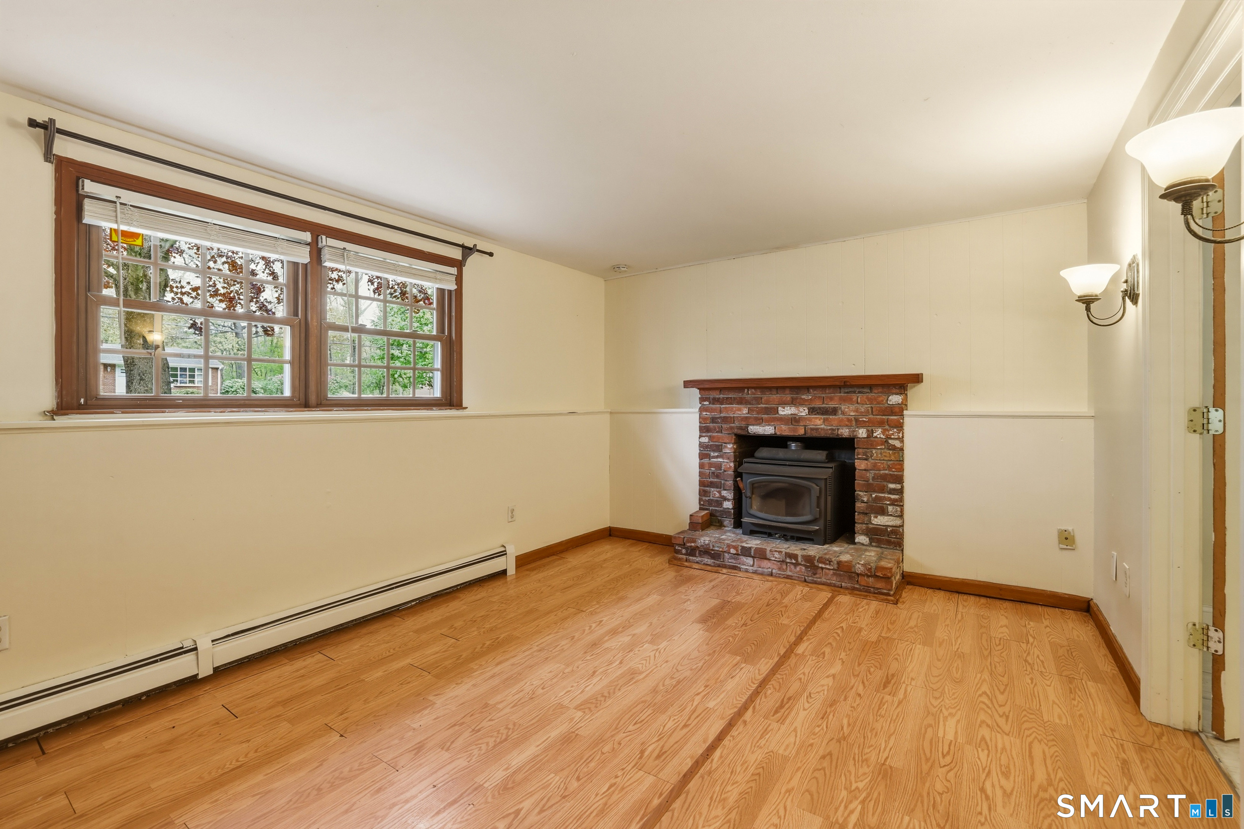 10 Salem Road Madison, CT 06443 - Photo 23 of 31 Laminate floors shine in the natural light of this gathering space.