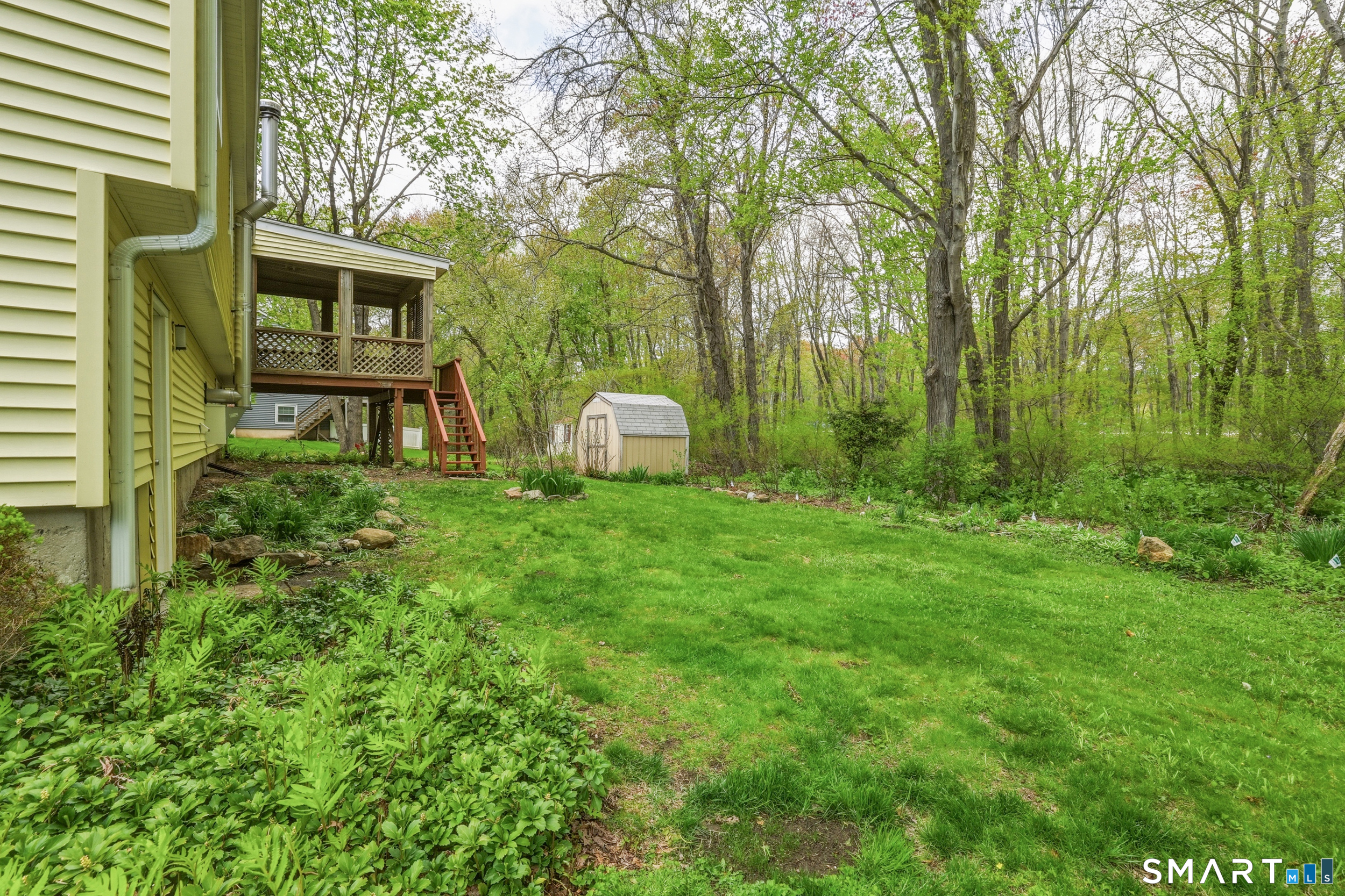 10 Salem Road Madison, CT 06443 - Photo 30 of 31 The lush back yard features a shed for storage and a tranquil brook running along the perimeter.