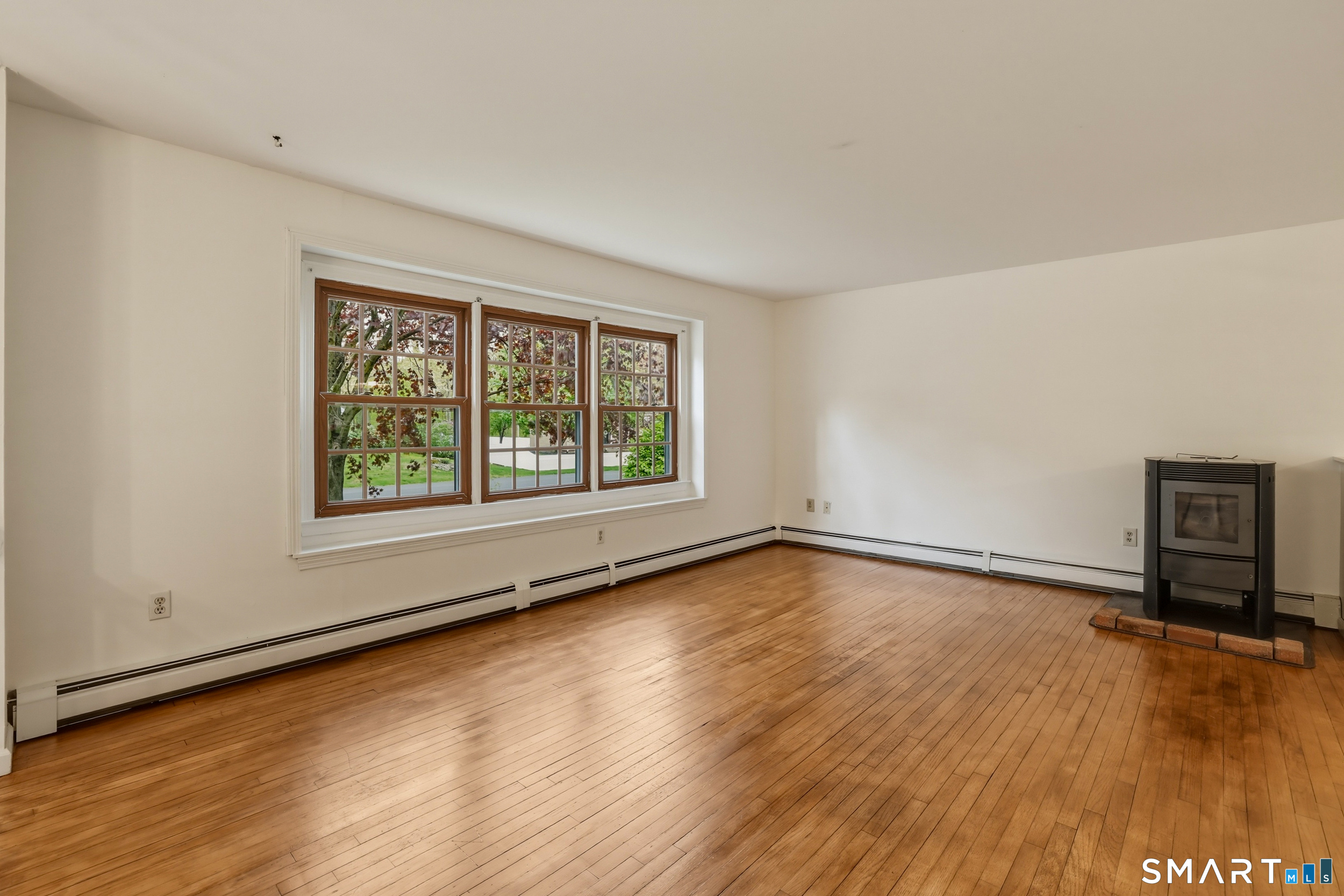 10 Salem Road Madison, CT 06443 - Photo 3 of 31 Featuring a Pellet Stove, this room radiates comfort and ease.
