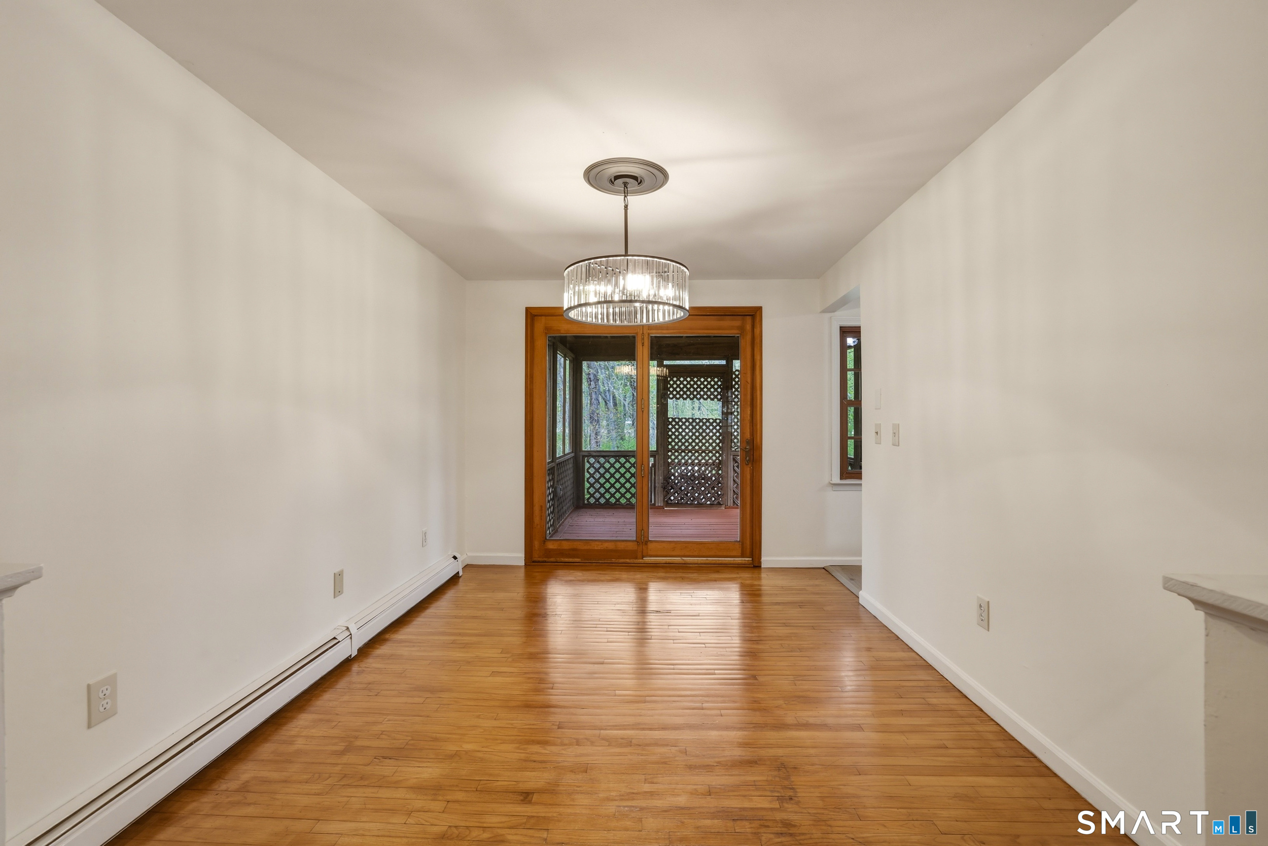 10 Salem Road Madison, CT 06443 - Photo 7 of 31 With refinished hardwood floors and a brand new modern chandelier, this dining area is begging for guests.