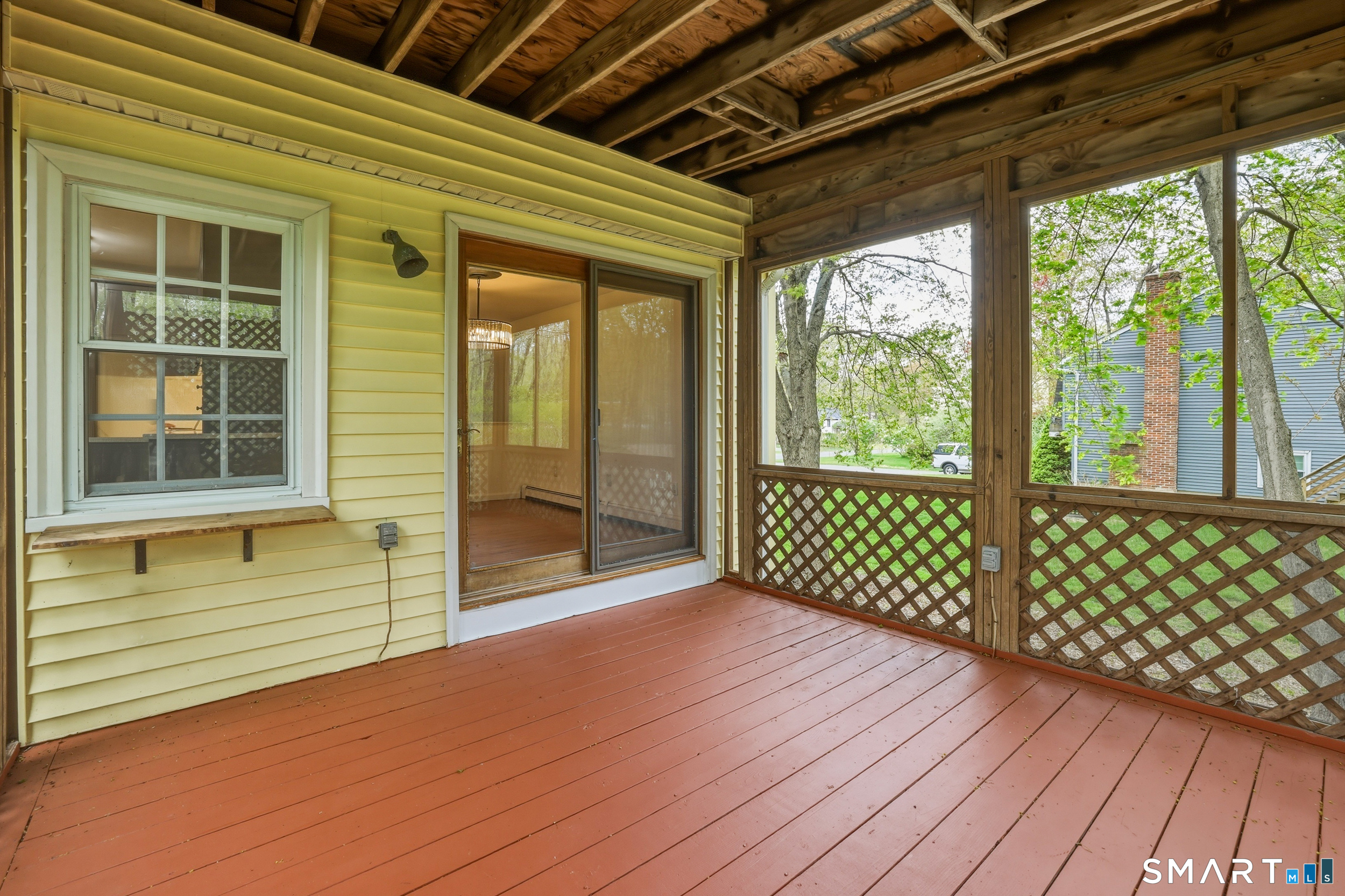 10 Salem Road Madison, CT 06443 - Photo 8 of 31 Spend your summer evenings sipping a drink or enjoying the nature around you from this large covered deck, directly off the dining area.