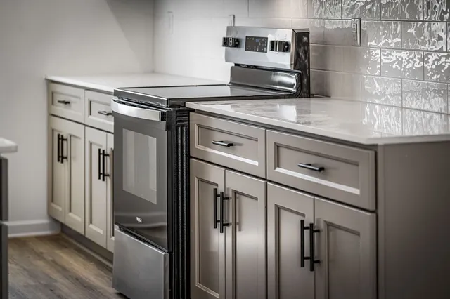 a kitchen with stainless steel appliances a refrigerator and cabinets
