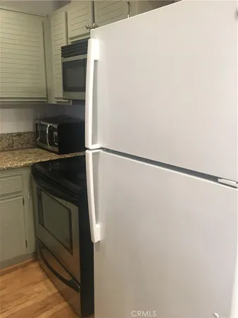 a kitchen with a refrigerator and a sink