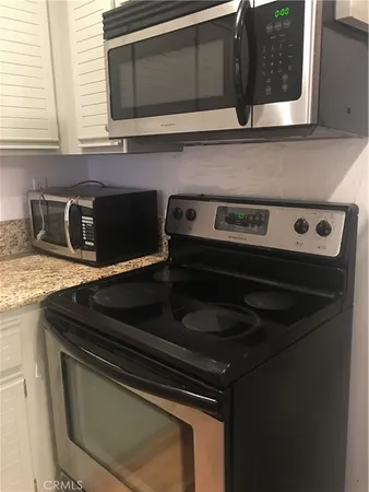 a stove top oven sitting inside of a kitchen