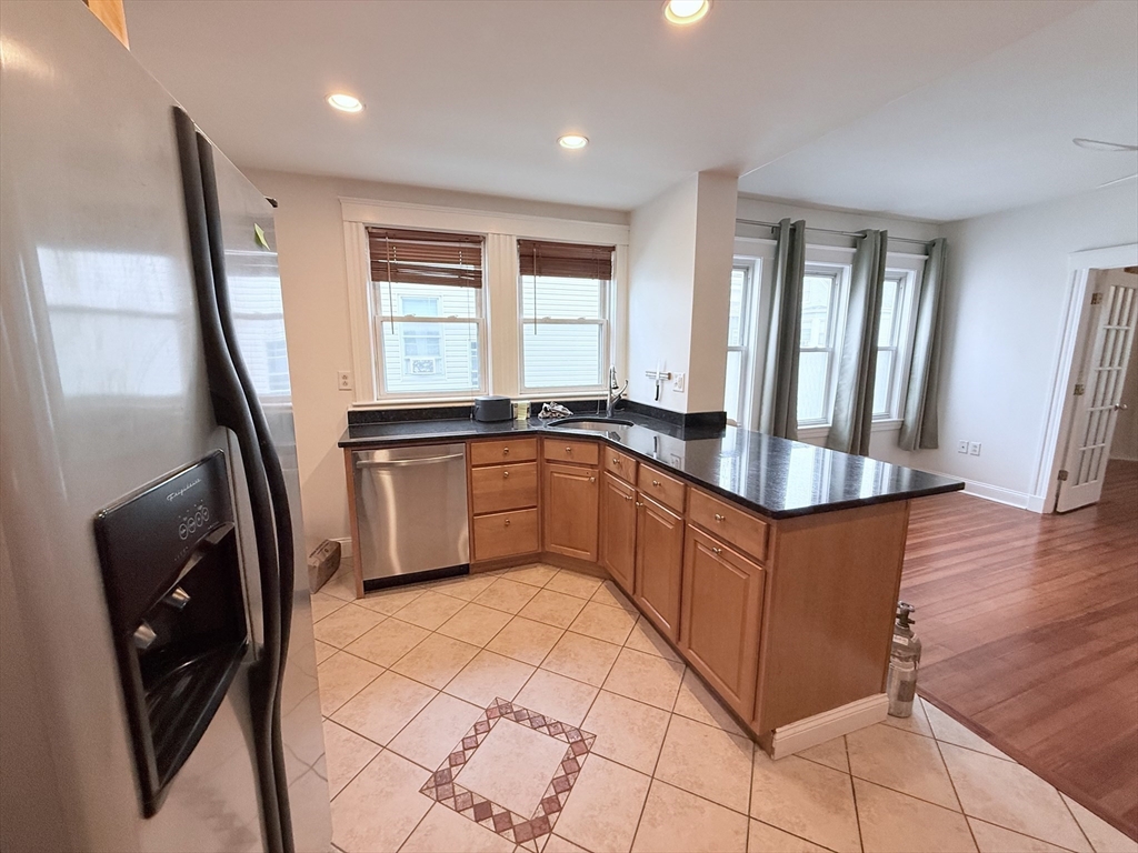 2 A Victoria Street, Unit 2A Boston, MA 02125 - Photo 2 of 13 a kitchen with stainless steel appliances granite countertop a refrigerator a sink a stove a microwave a sink and dishwasher