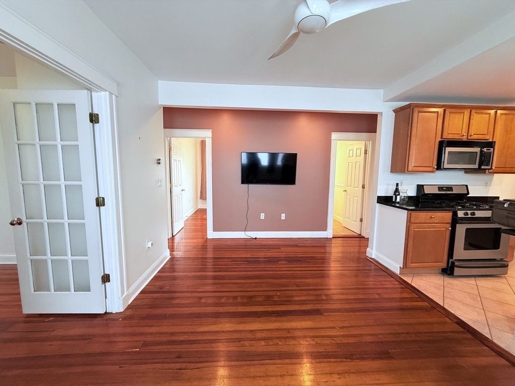 2 A Victoria Street, Unit 2A Boston, MA 02125 - Photo 4 of 13 a view of a living room with wooden floor and a window