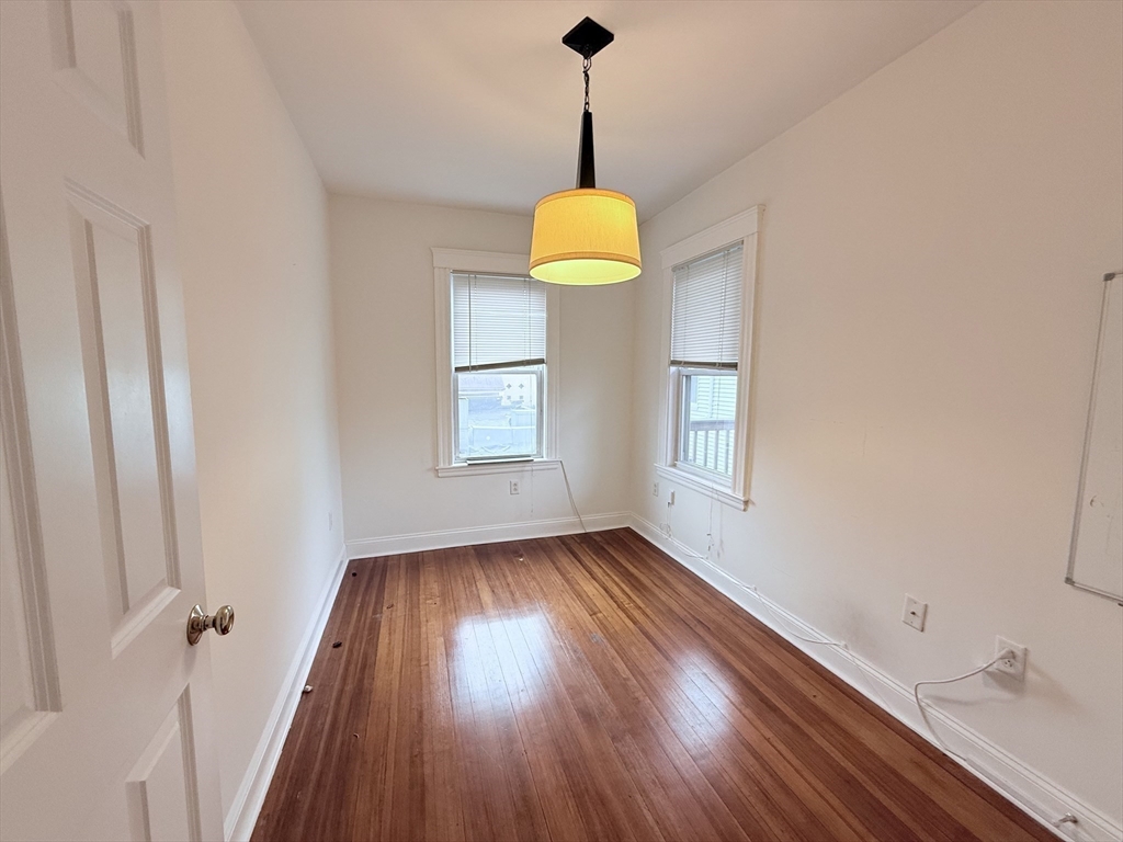 2 A Victoria Street, Unit 2A Boston, MA 02125 - Photo 8 of 13 a view of an empty room with wooden floor and a window