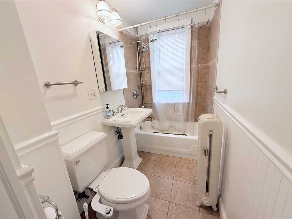 2 A Victoria Street, Unit 2A Boston, MA 02125 - Photo 9 of 13 a white toilet sitting next to a bathroom sink