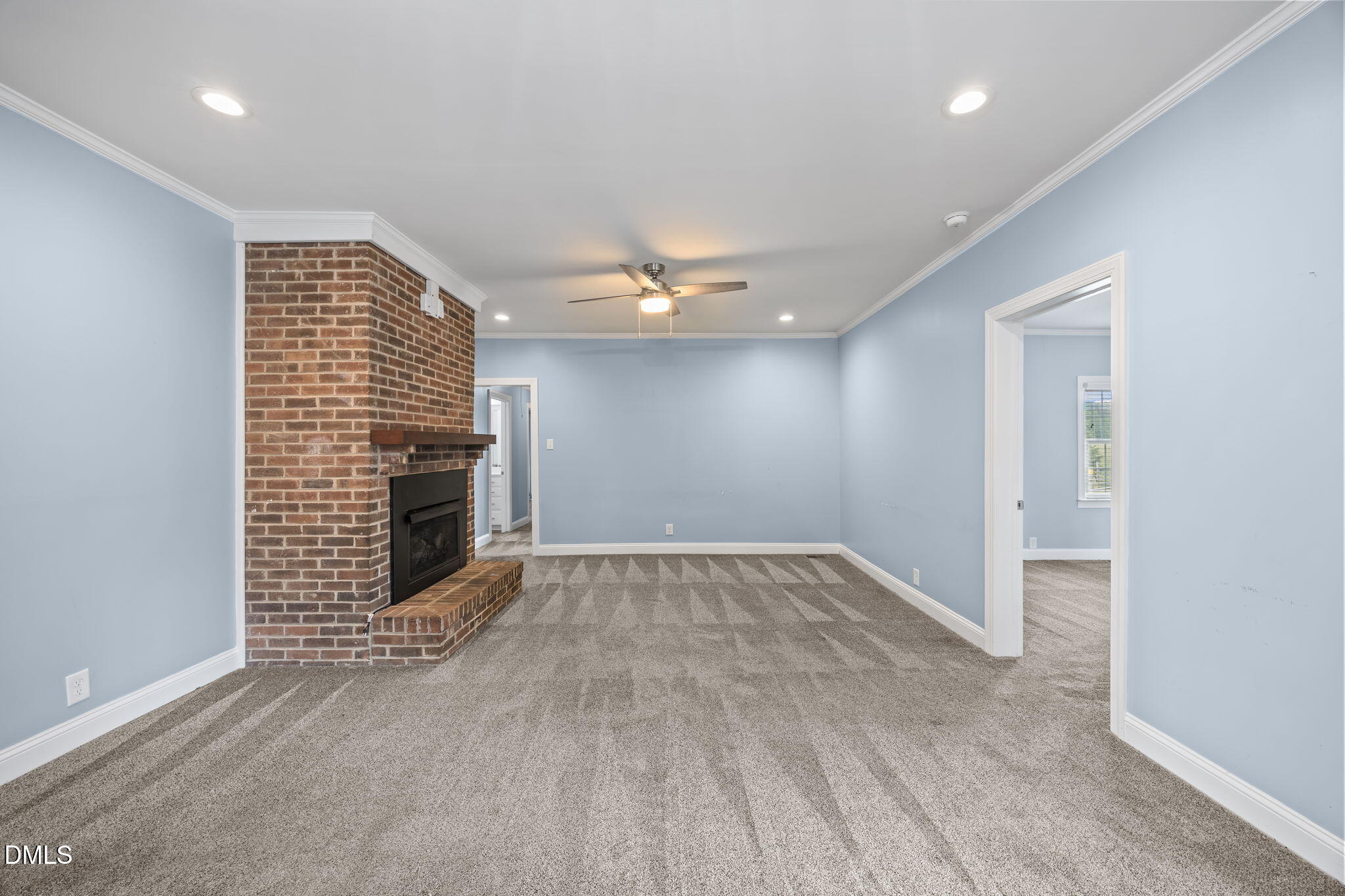 3611 Chewning Road Oxford, NC 27565 - Photo 6 of 45 an empty room with a fireplace and painted walls