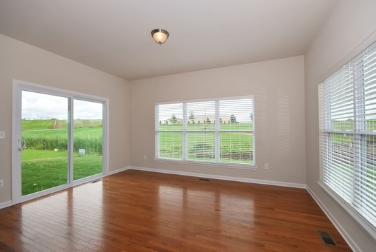 40W221 Palmer Road Geneva, IL 60134 - Photo 14 of 22 a view of an empty room with wooden floor and a window