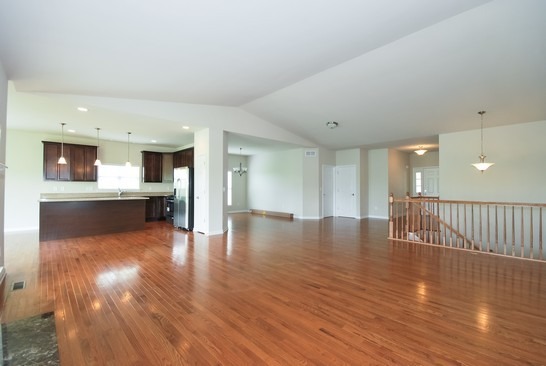 40W221 Palmer Road Geneva, IL 60134 - Photo 15 of 22 a view of a kitchen and an empty room with wooden floor