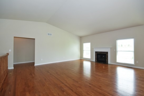 40W221 Palmer Road Geneva, IL 60134 - Photo 3 of 22 a view of an empty room with wooden floor and a fireplace
