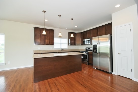 40W221 Palmer Road Geneva, IL 60134 - Photo 4 of 22 a kitchen with stainless steel appliances granite countertop a refrigerator a sink dishwasher a stove and a wooden floor