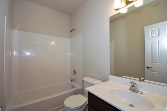 40W221 Palmer Road Geneva, IL 60134 - Photo 5 of 22 a bathroom with a sink a toilet and shower