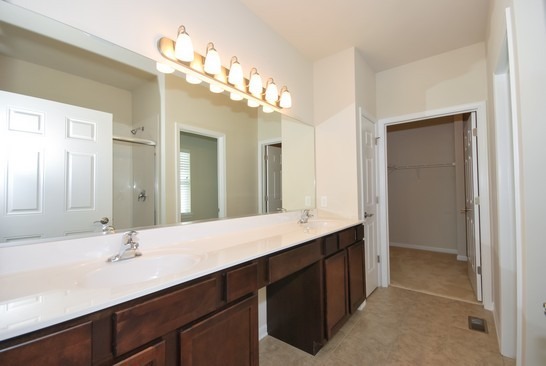 40W221 Palmer Road Geneva, IL 60134 - Photo 6 of 22 a bathroom with a double vanity sink and a mirror