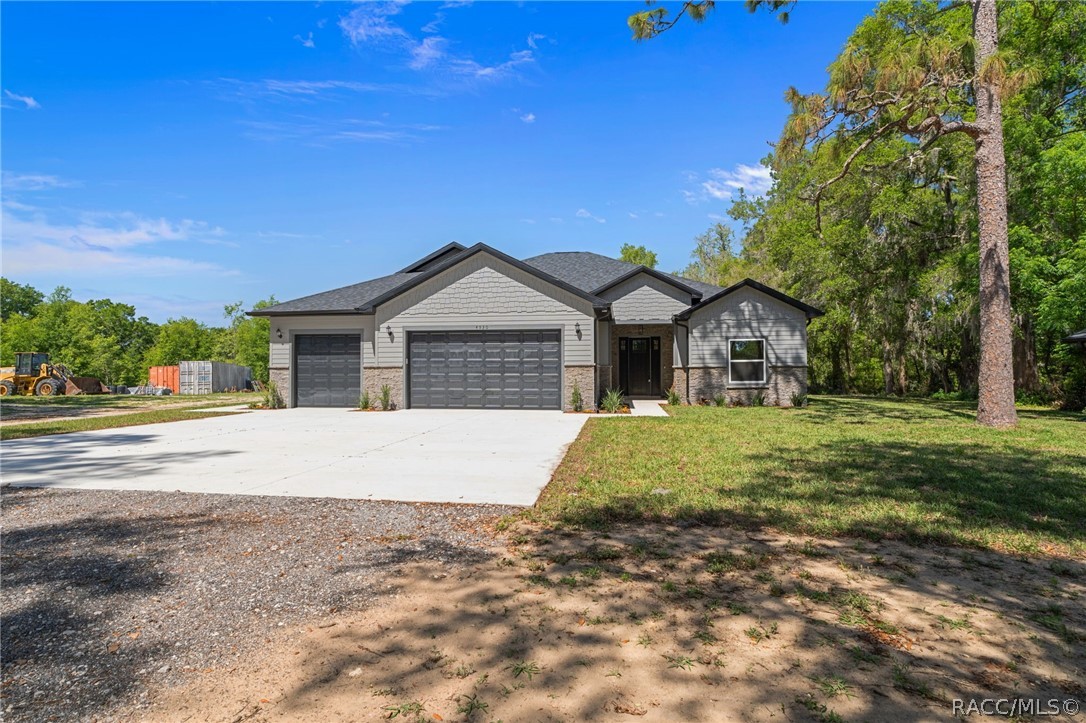 4530 South Florida Avenue Inverness, FL 34450 - Photo 2 of 100 a front view of a house with a yard and garage