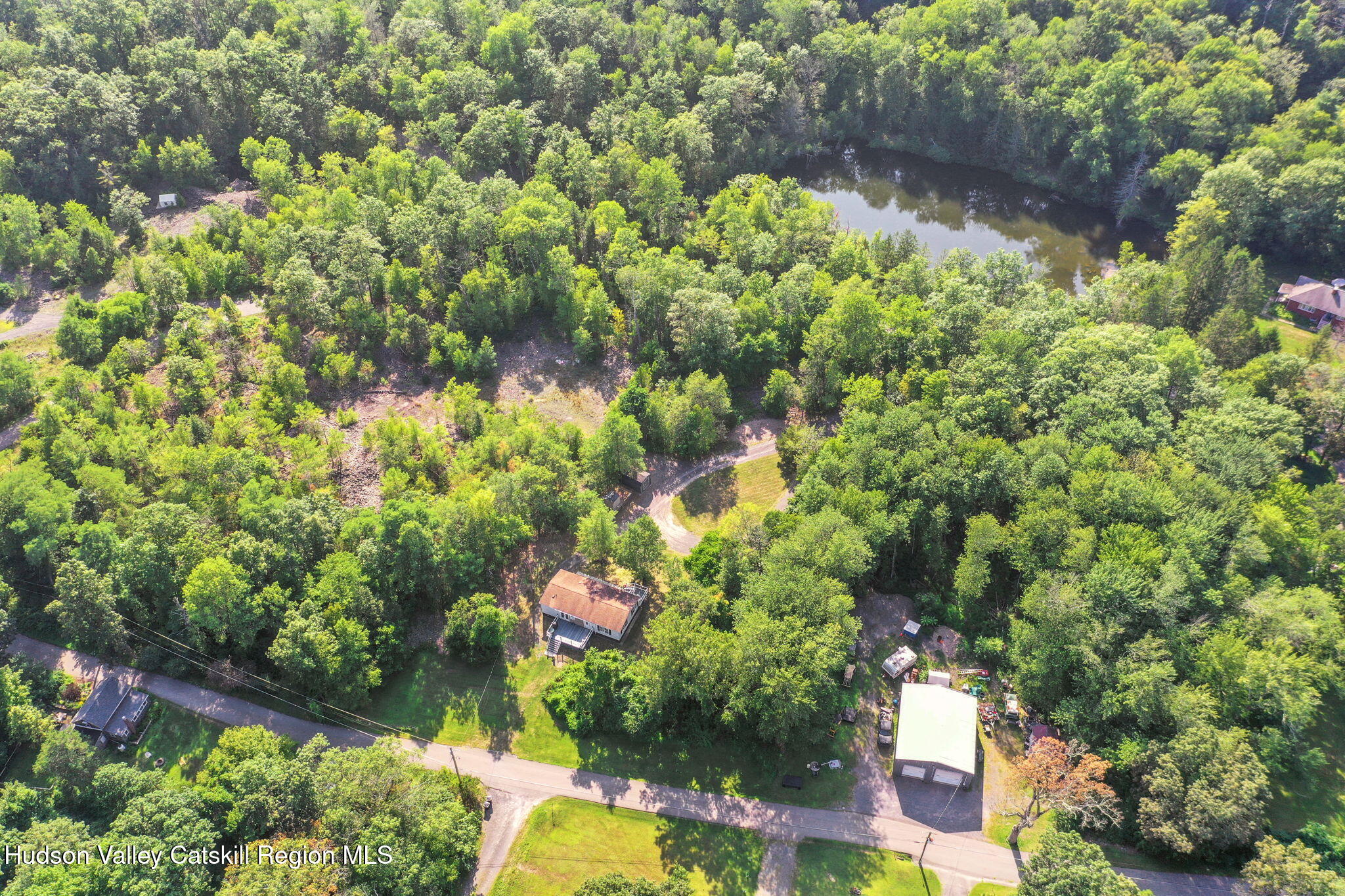 135 Patch Road Saugerties, NY 12477 - Photo 18 of 21 a backyard of a house with lots of green space and a fountain