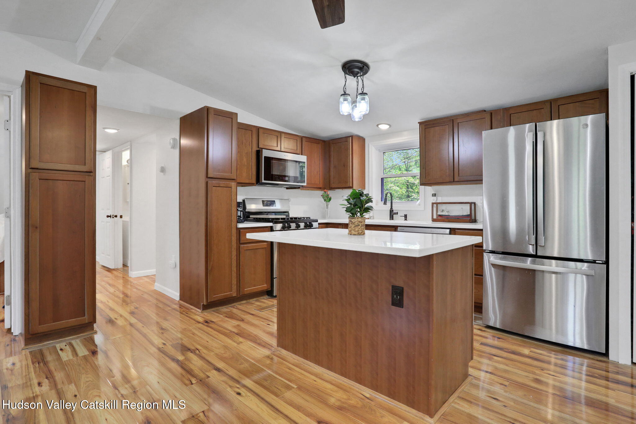 135 Patch Road Saugerties, NY 12477 - Photo 2 of 21 a kitchen with kitchen island stainless steel appliances a refrigerator cabinets and wooden floor