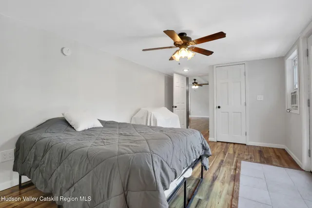 a bedroom with a bed and a ceiling fan