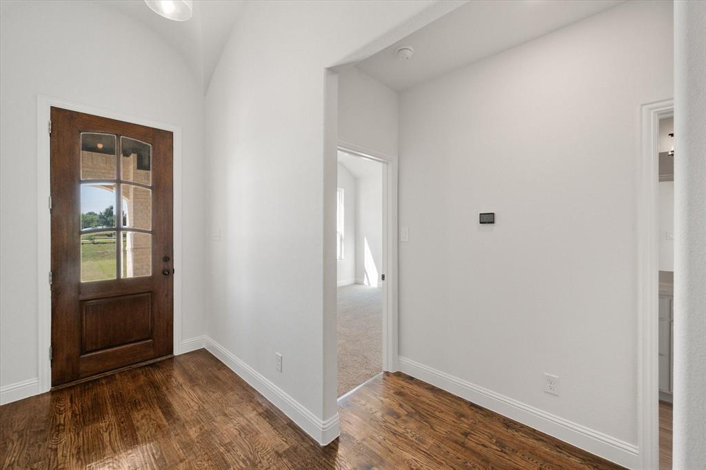 3400 Dobbins Road Corsicana, TX 75110 - Photo 3 of 40 a view of an empty room with wooden floor and a window
