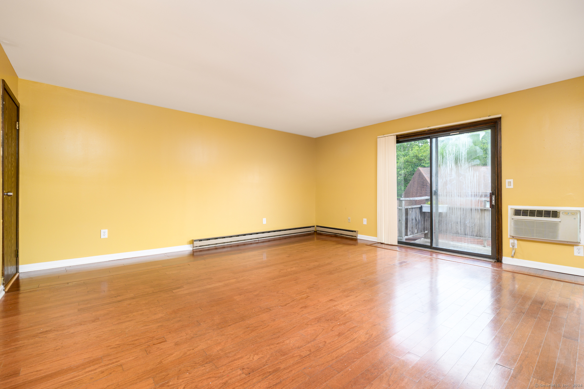 22 Radio Place, Unit 10 Stamford, CT 06906 - Photo 2 of 14 a view of an empty room with wooden floor and a window