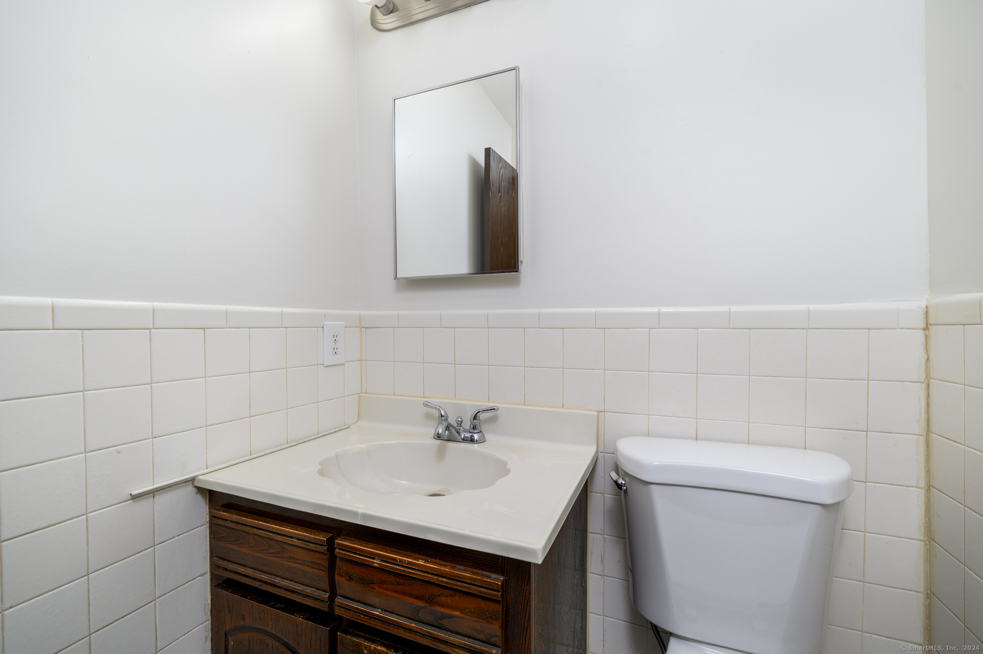 22 Radio Place, Unit 10 Stamford, CT 06906 - Photo 9 of 14 a bathroom with a sink toilet and mirror
