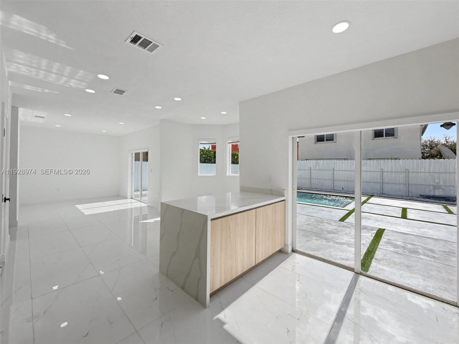 15064 Southwest 30th Terrace Miami, FL 33185 - Photo 13 of 60 a kitchen with stainless steel appliances kitchen island granite countertop a sink and cabinets