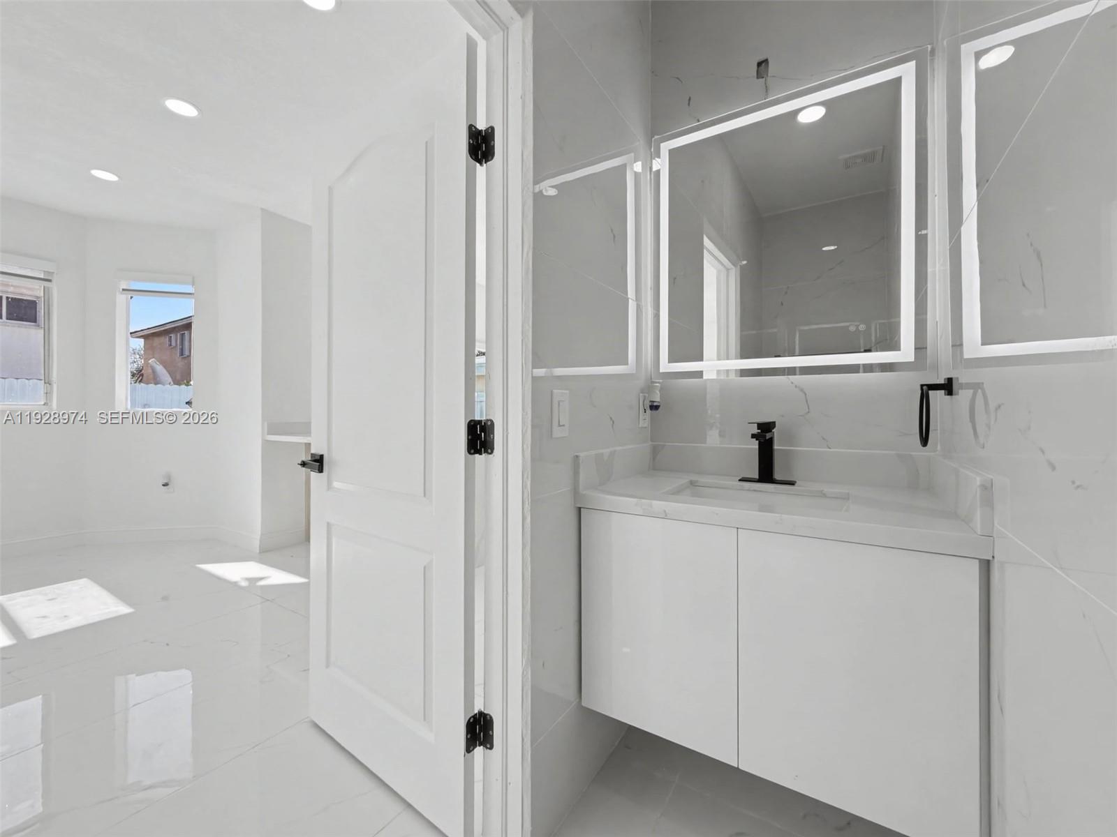 15064 Southwest 30th Terrace Miami, FL 33185 - Photo 17 of 60 a bathroom with a sink and mirror