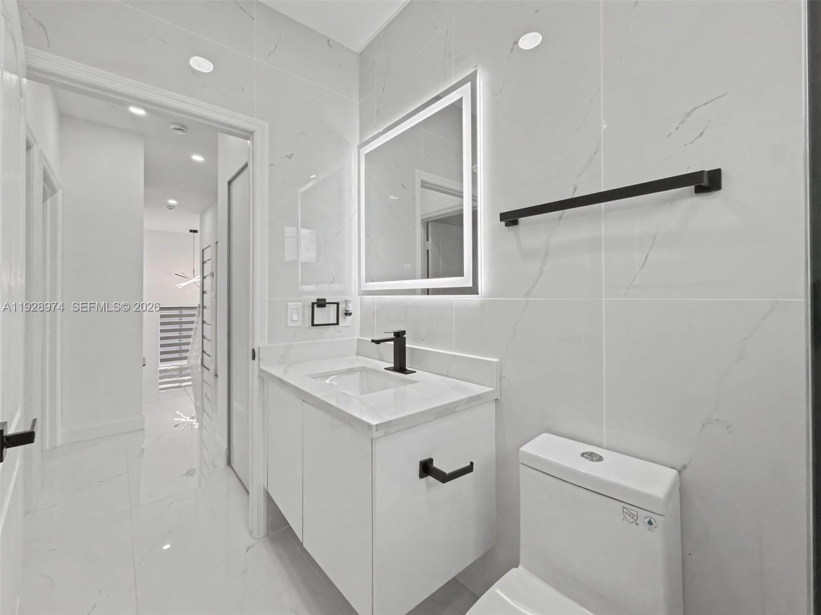 15064 Southwest 30th Terrace Miami, FL 33185 - Photo 24 of 60 a bathroom with a sink toilet vanity and shower