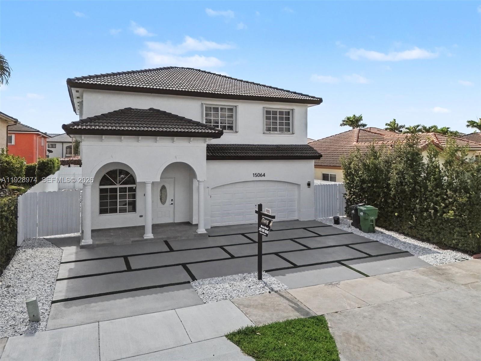 15064 Southwest 30th Terrace Miami, FL 33185 - Photo 3 of 60 a front view of a house with a yard