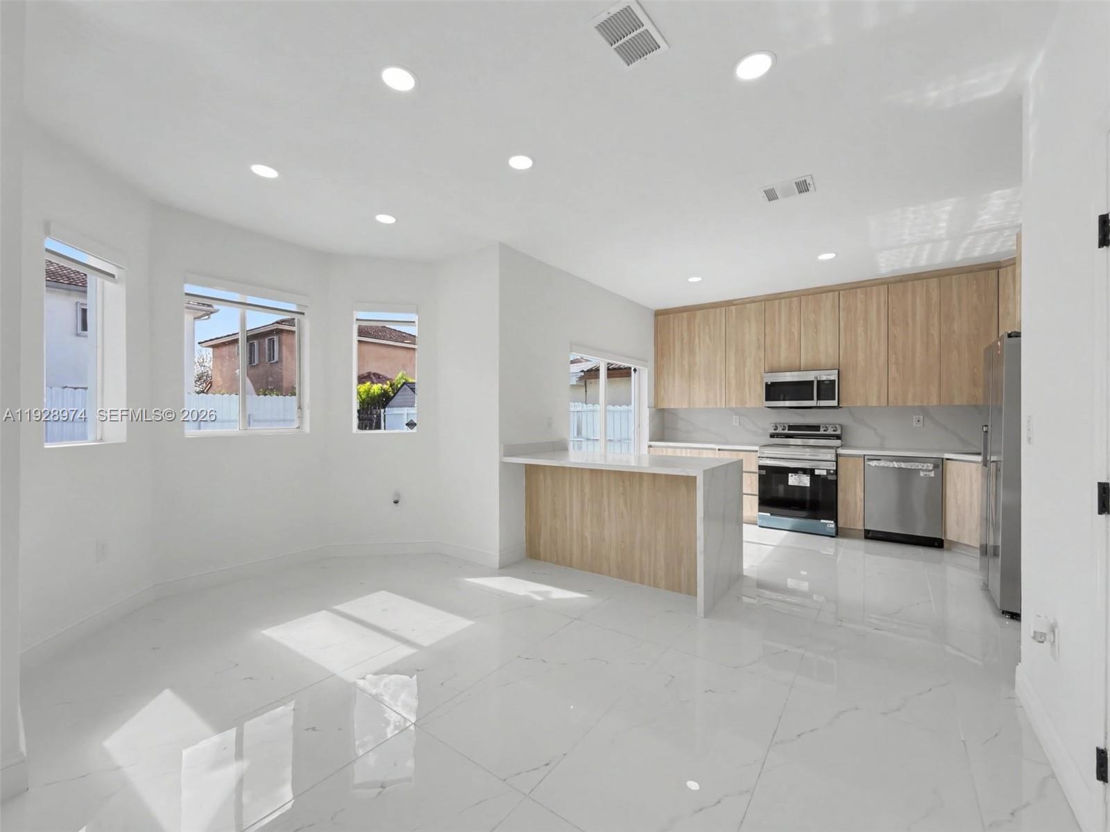 15064 Southwest 30th Terrace Miami, FL 33185 - Photo 4 of 60 a large kitchen with stainless steel appliances lots of counter top space and cabinets