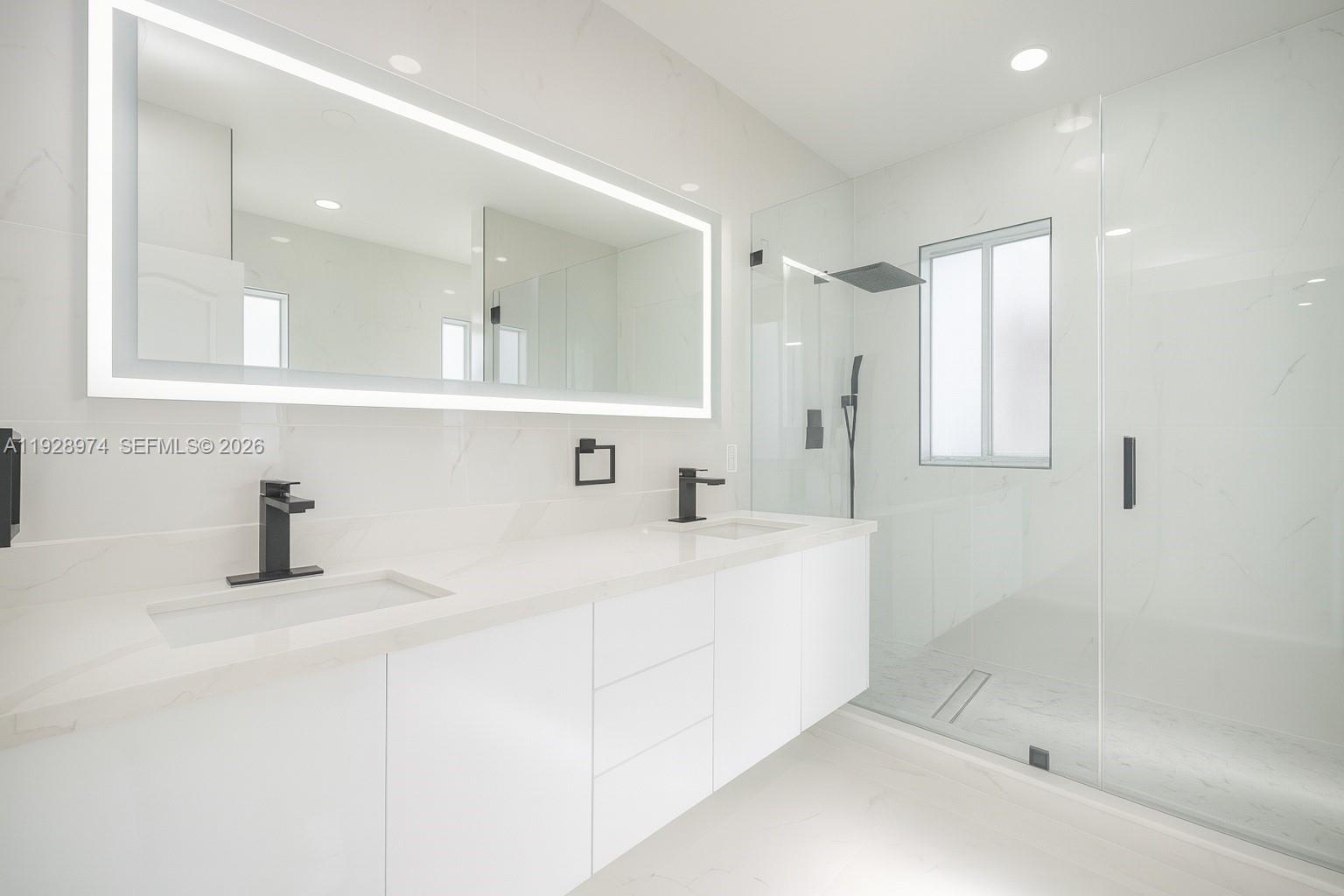 15064 Southwest 30th Terrace Miami, FL 33185 - Photo 44 of 60 a bathroom with a bathtub sink and mirror