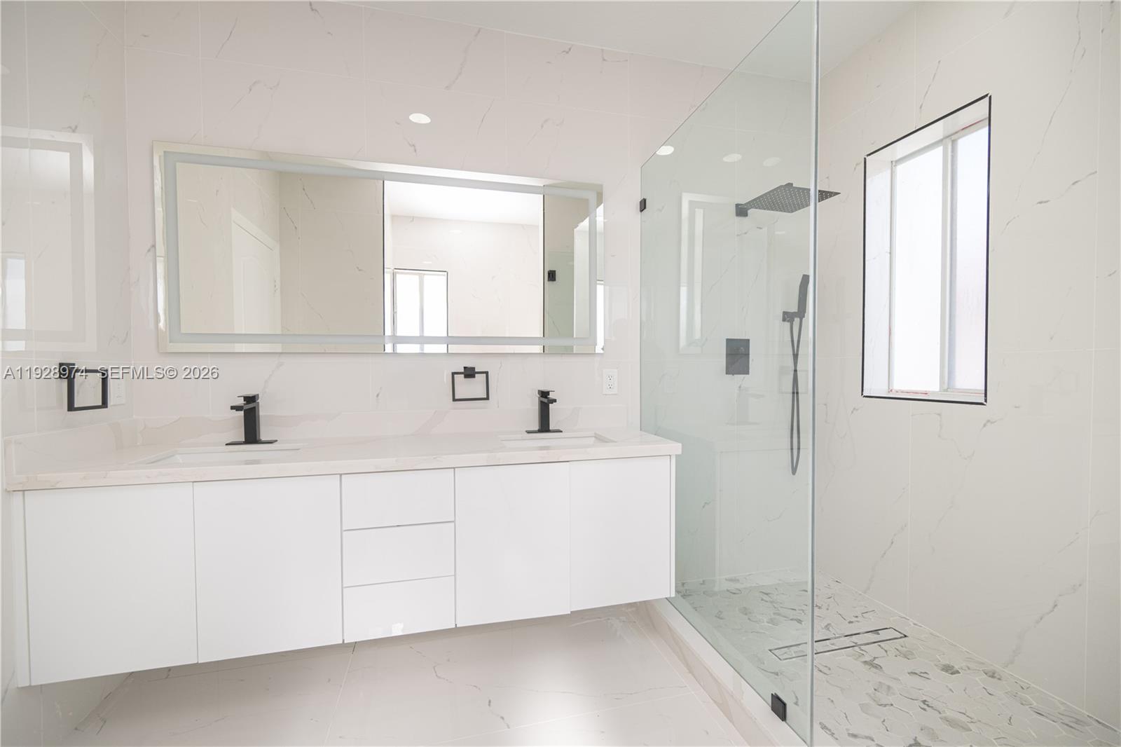 15064 Southwest 30th Terrace Miami, FL 33185 - Photo 45 of 60 a spacious bathroom with double vanity and a shower