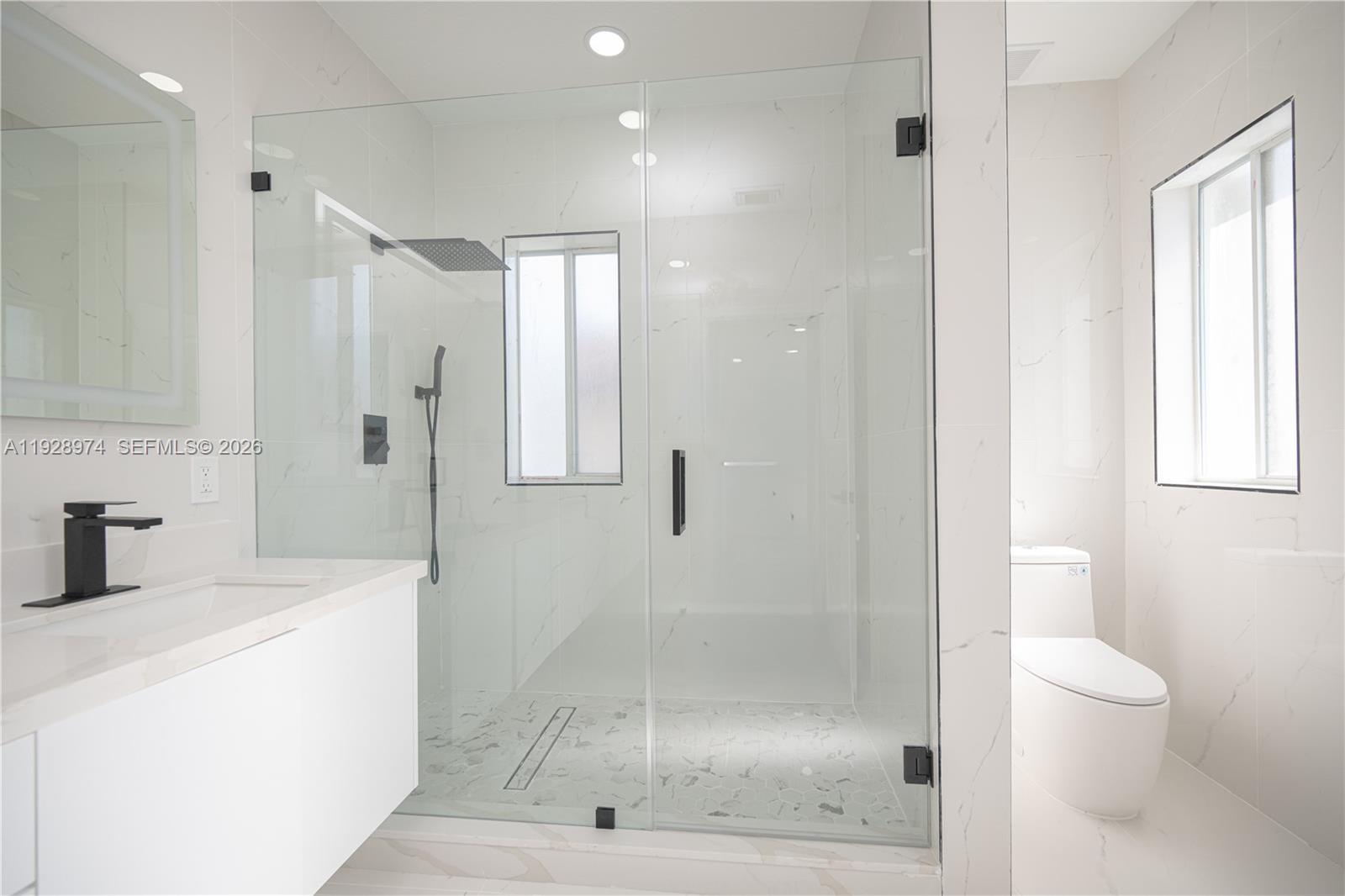 15064 Southwest 30th Terrace Miami, FL 33185 - Photo 46 of 60 a bathroom with a shower a toilet and sink