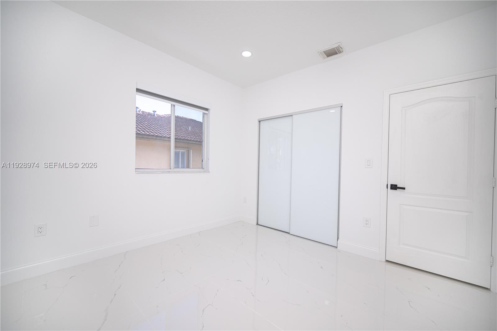 15064 Southwest 30th Terrace Miami, FL 33185 - Photo 53 of 60 an empty room with windows