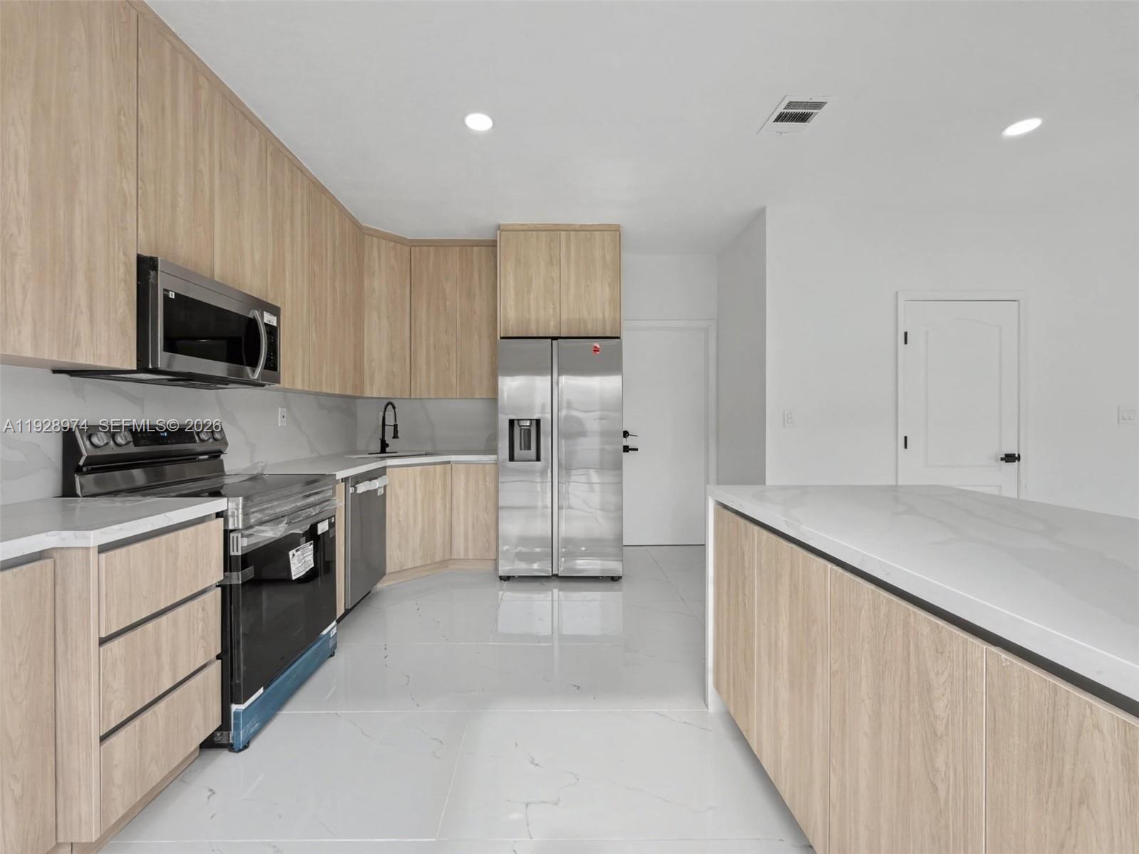15064 Southwest 30th Terrace Miami, FL 33185 - Photo 8 of 60 a kitchen with granite countertop white cabinets and stainless steel appliances
