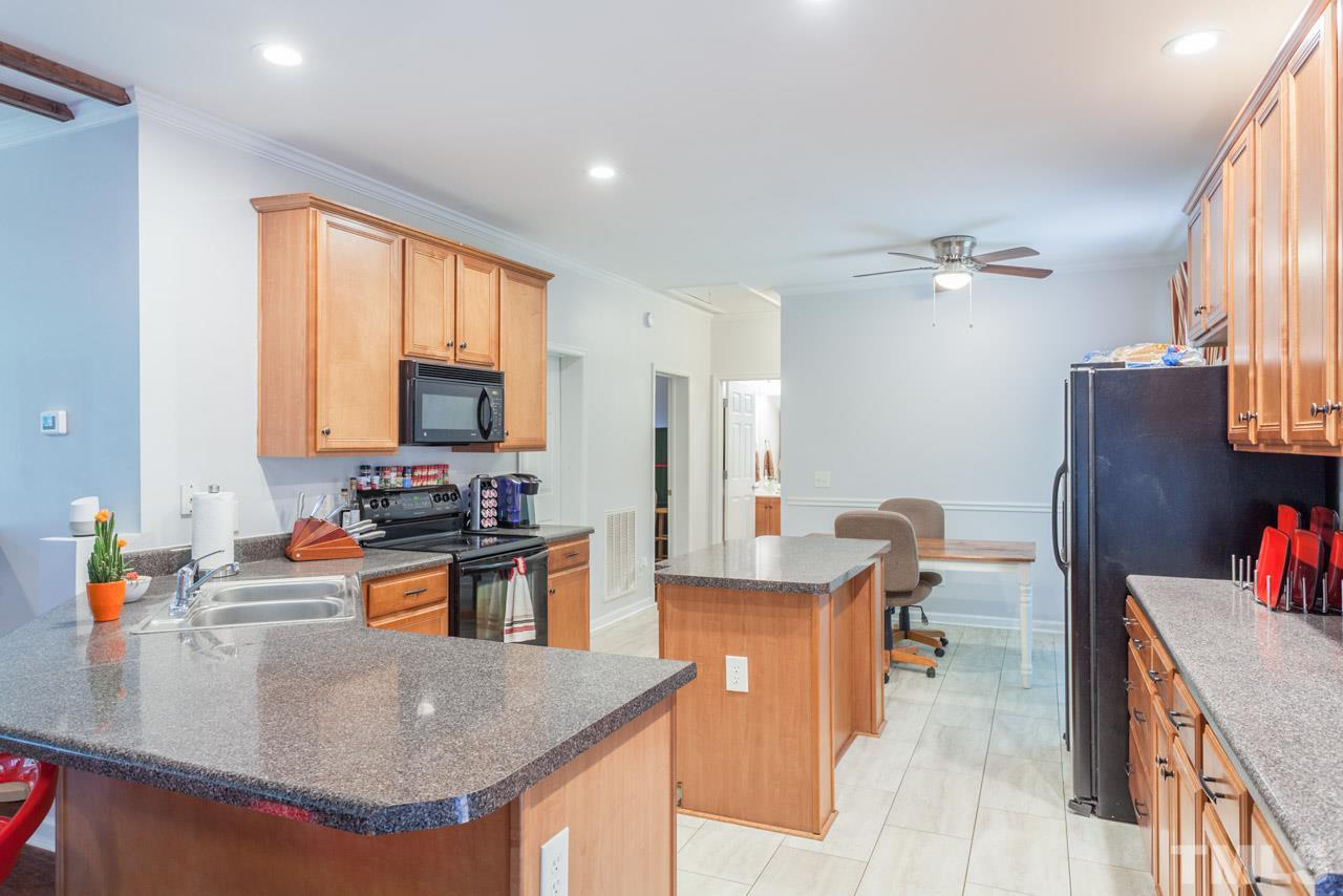 2092 Suitts Store Road Franklinton, NC 27525 - Photo 6 of 21 a kitchen with stainless steel appliances granite countertop a sink a stove and a refrigerator